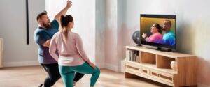 Fat active couple watching active exercise tv